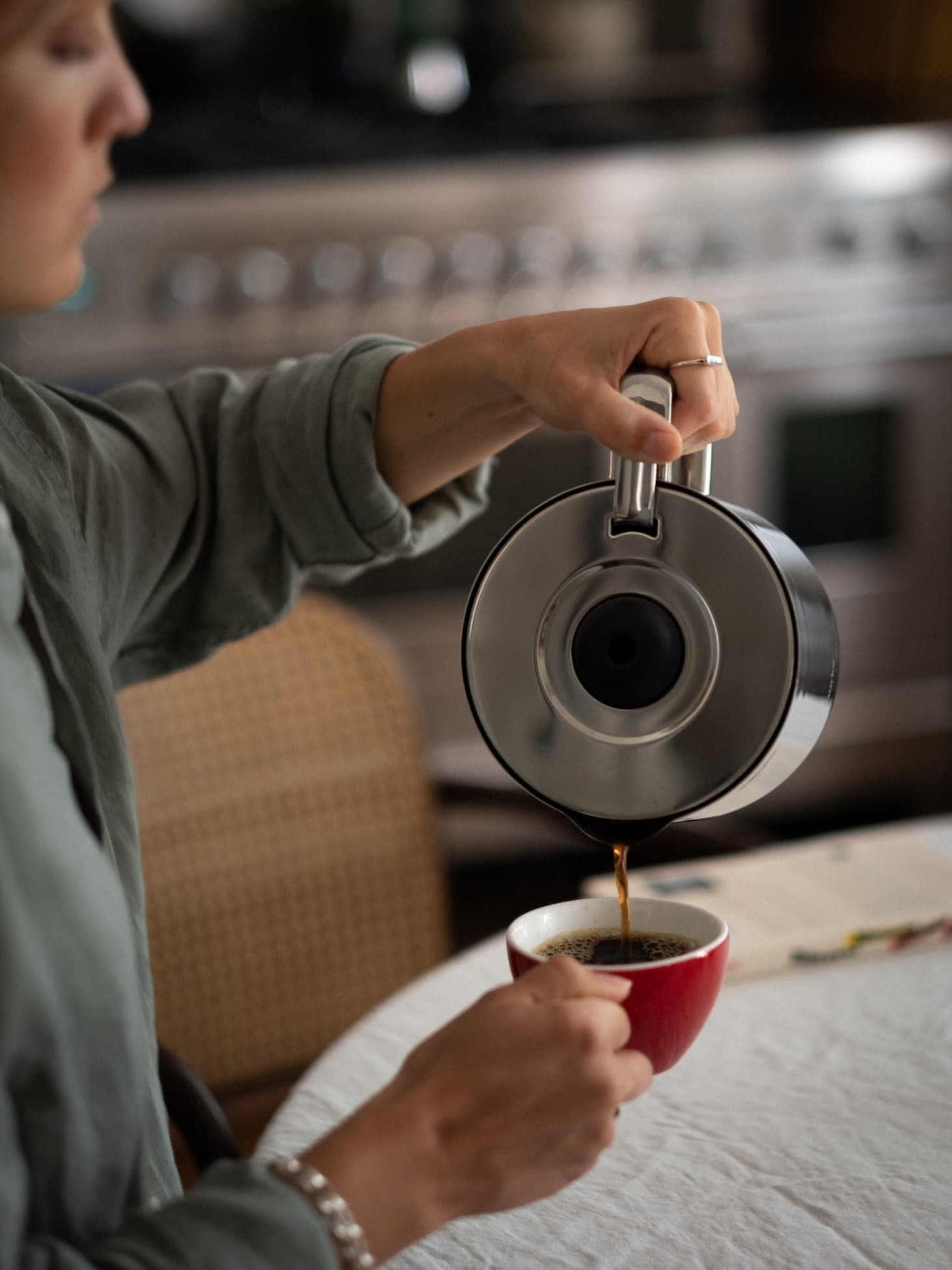 Aarke Thermal Jug at home with woman pouring coffee