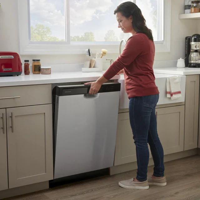 PERSON OPENING A DISHWASHER