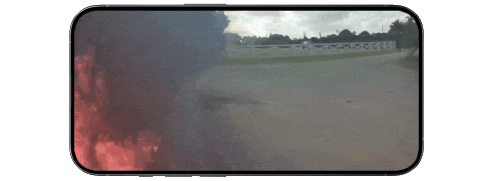 Point of view image showing the start of a wildfire near a road.