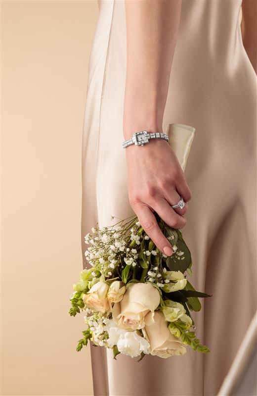 image of silver Ava watch on wrist holding flowers