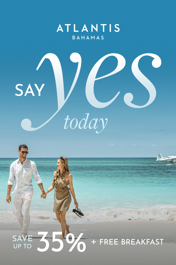 Woman and man walking on a white-sand beach at Atlantis Paradise Island with text promoting up to 35% off, free daily breakfast for two, and a bonus room upgrade.