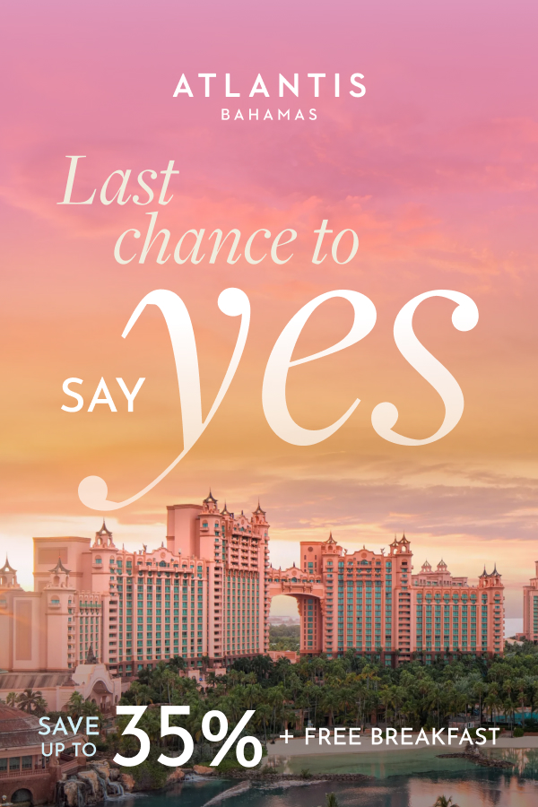 Woman and man walking on a white-sand beach at Atlantis Paradise Island with text promoting up to 35% off, free daily breakfast for two, and a bonus room upgrade.