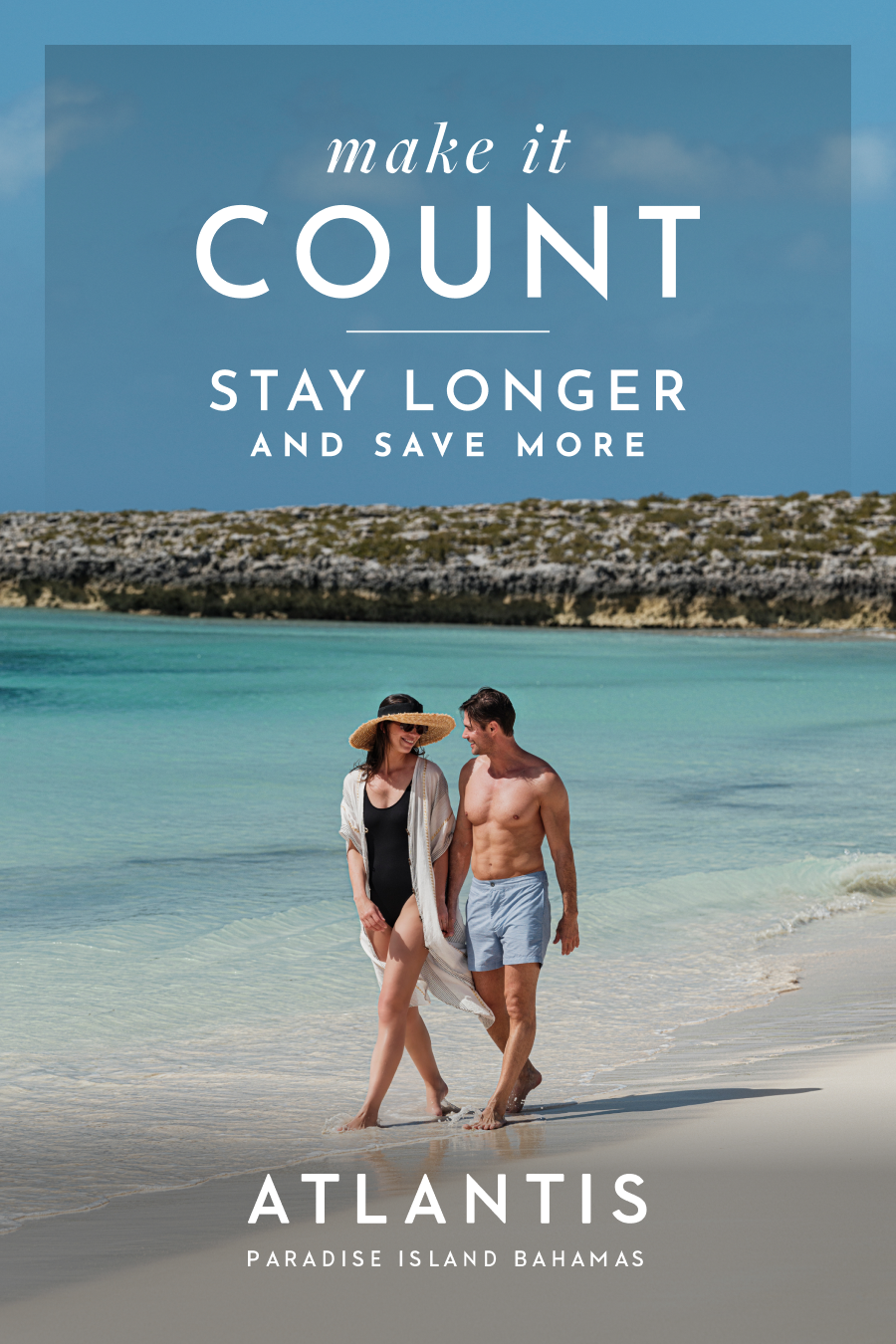 Make It Count: Stay Longer and Save More at Atlantis Bahamas. | A couple holding hands walks along a white-sand beach next to clear turquoise water.