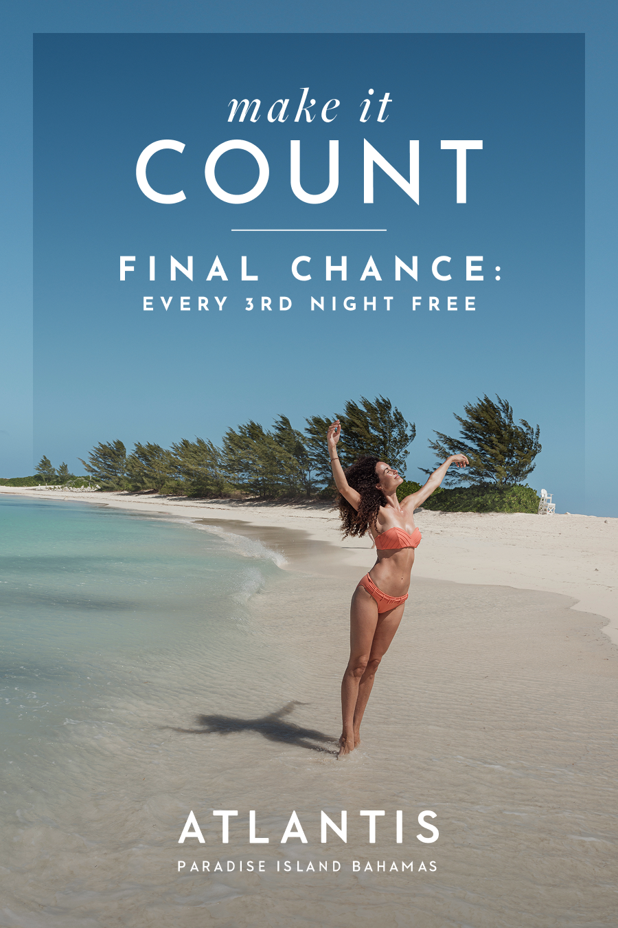 Make It Count: Final chance, every 3rd night free at Atlantis Bahamas. | A woman in a bikini joyfully posing on a white sand beach by the ocean.