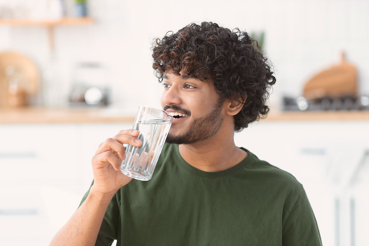 Young man drinking Atla water.