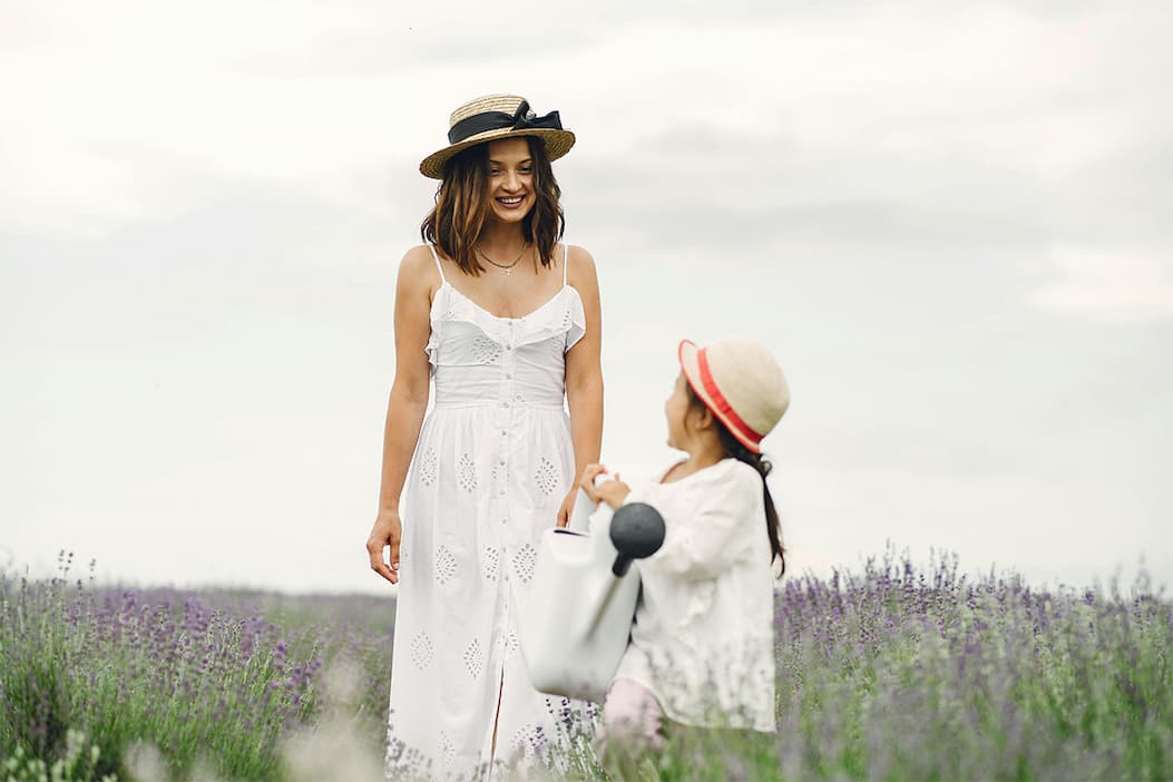 Mother and daughter stroll through lavender field