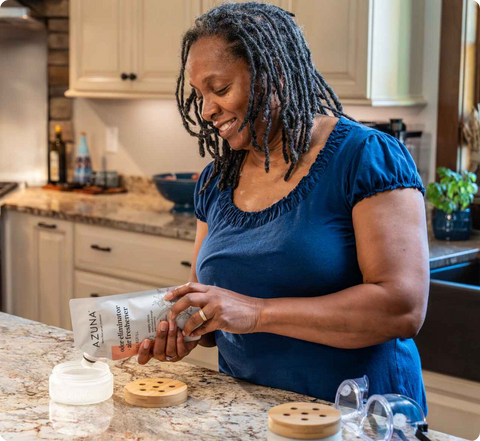 Women filling glass jars with Azuna gel