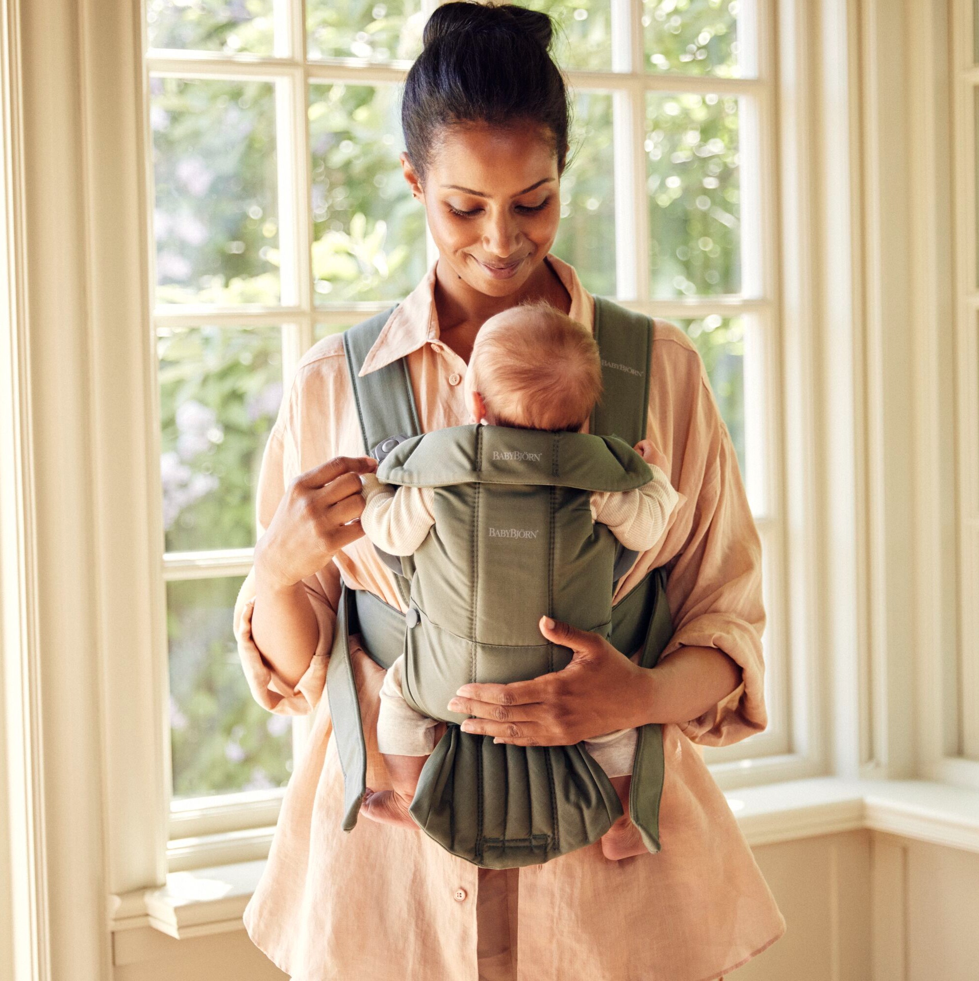 mom babywearing small baby in baby carrier mini