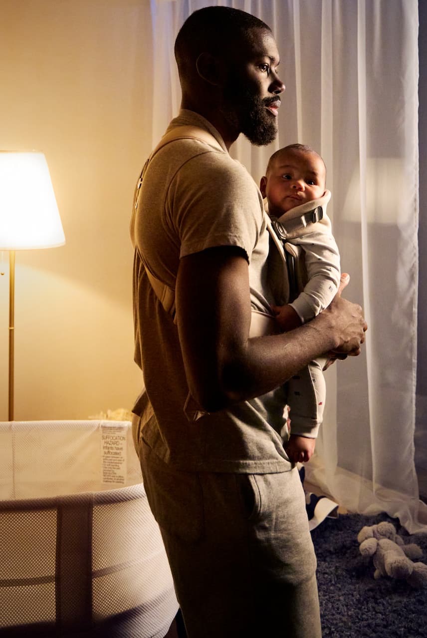 man holding baby in carrier 