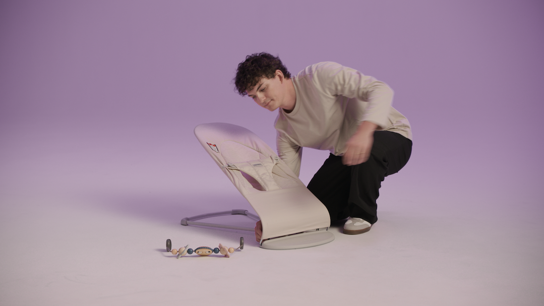 man adjusting baby bouncer 