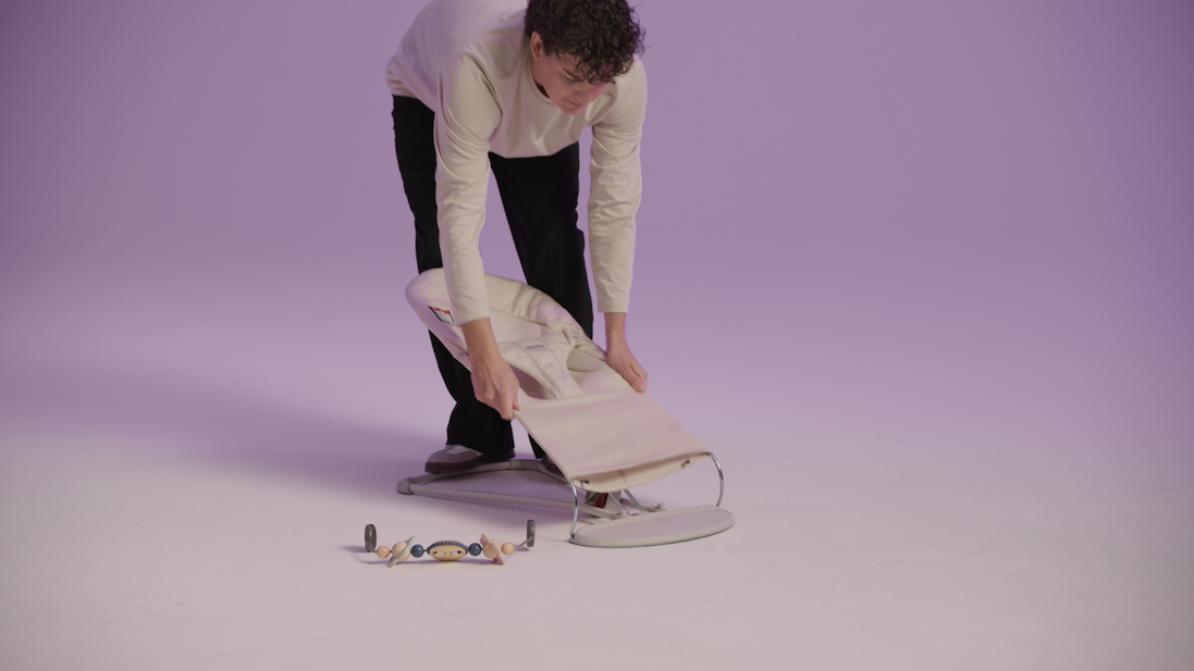 man adjusting baby bouncer 