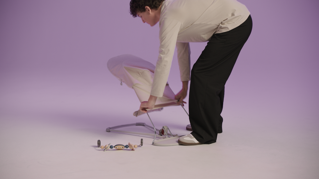 man adjusting baby bouncer 