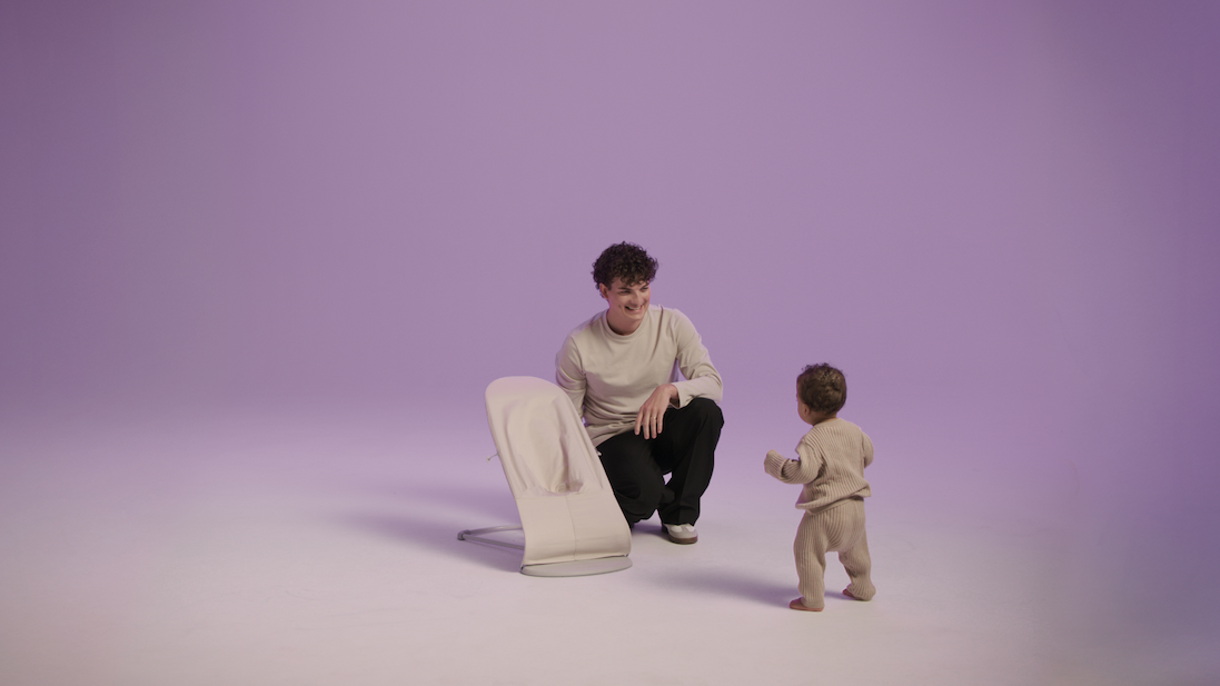 man adjusting baby bouncer 