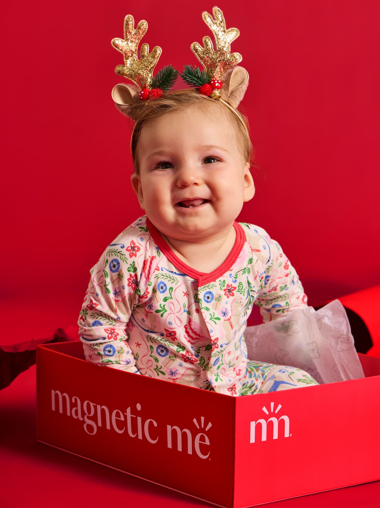 baby in onesie with reindeer headband