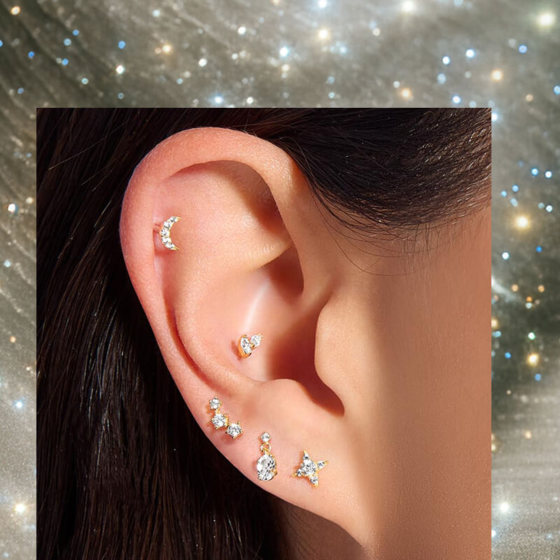 Woman's ear displaying multiple flat back earrings.