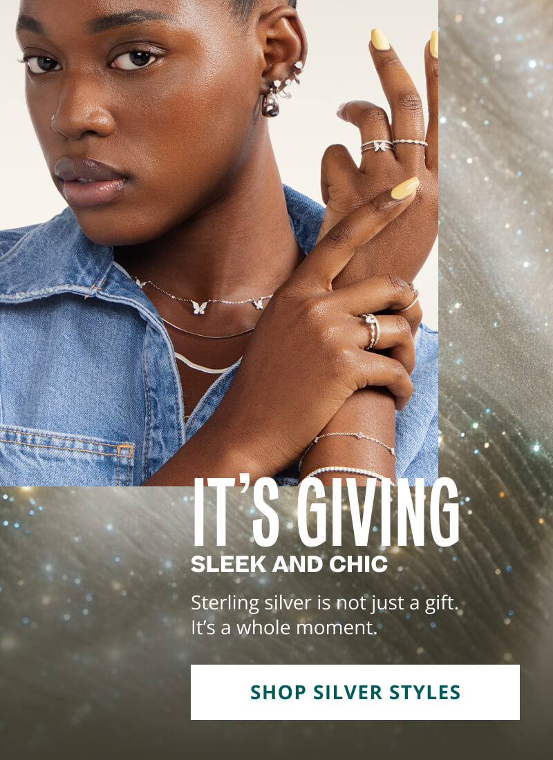 Model wearing varied silver jewelry. it’s giving: seek and chic. Silver is a moment. Click here to shop silver styles