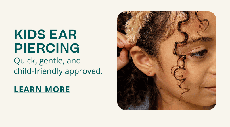 Child posing, showing pink gemstone stud in her ear. Kids ear piercing. Quick, and gentle. Click here to learn more