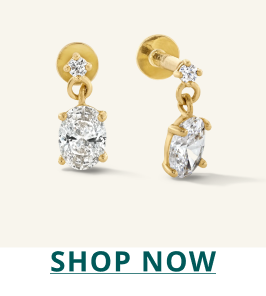 Pair of gold and diamond drop earrings. Click here to shop now