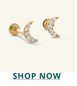 Pair of gold crescent moon-shaped diamond earrings. Click here to shop now