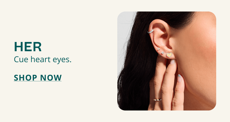Model’s ear with unique gold and diamond studs and huggie. Her. Cue her heart eyes. Click here to shop now