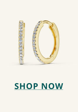 Gold huggie earring with diamond exterior. Click here to shop now