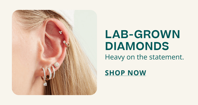 Ear with assortment of diamond studs, huggies and hoops. Lab-grown diamonds. Heavy on the statement. Click here to shop now