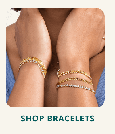Ear stack with gold hoops, diamond studs and hanging earrings. Click here to shop earrings