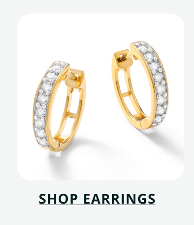 Gold huggies encrusted with pavé-set diamonds. Click here to shop earrings