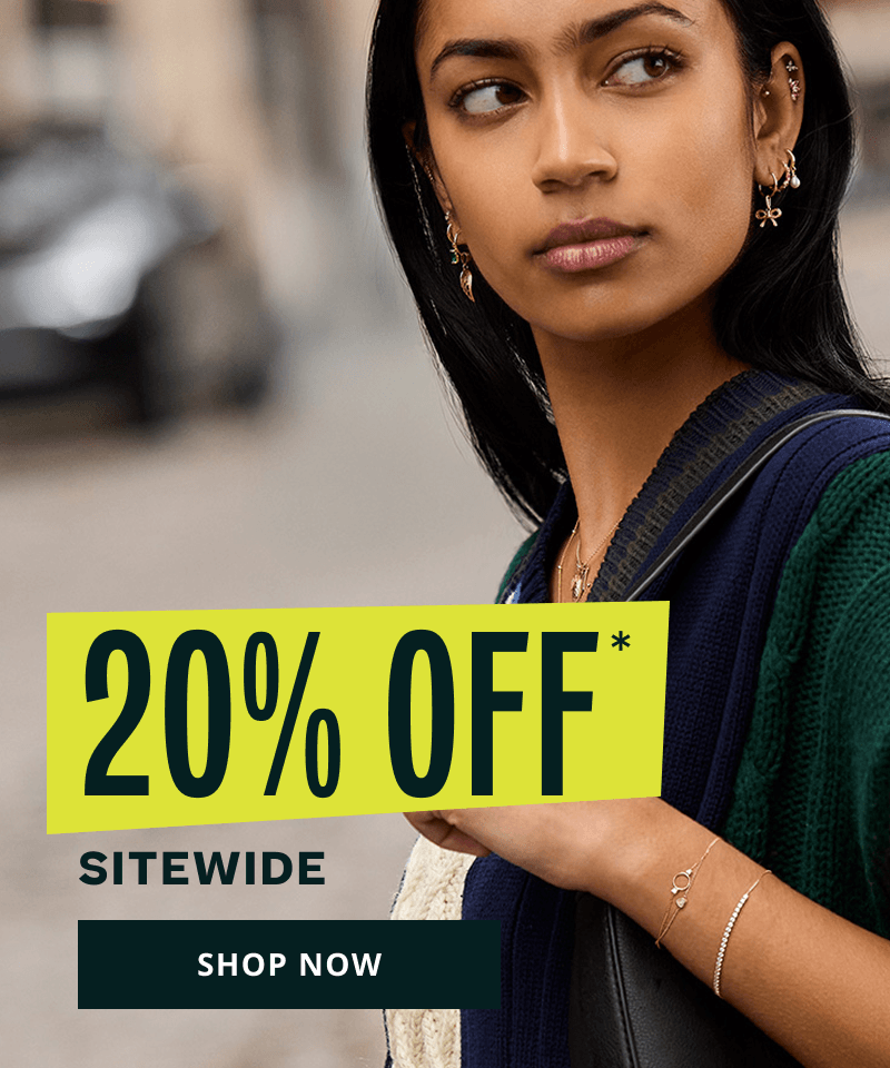 Model’s gold ear stack with charm elements, paired with gold chain bracelets & pendant necklaces. 20% OFF Sitewide. Click here to shop now