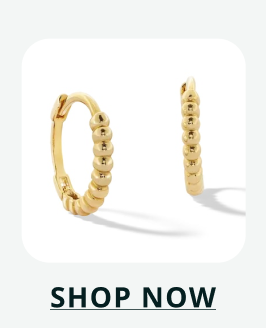 Gold huggie hoop earrings with a textured, beaded 