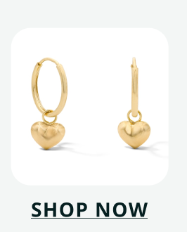 Pair of gold toned sleeper hoops with puffed heart charms that dangle. Click here to shop now