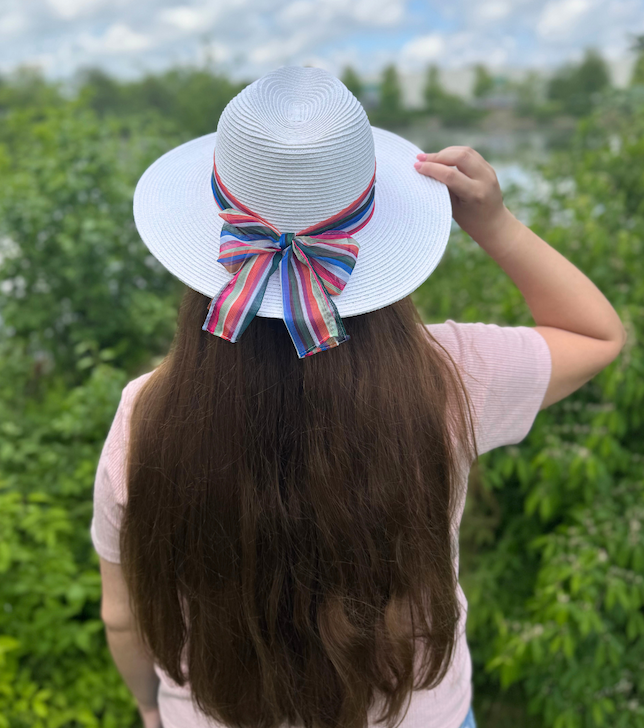 Woman wearing Karen Keith Women's Toyo Braid Straw Sun Hat with Chiffon Hatband