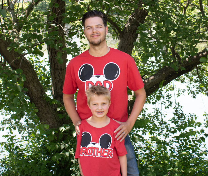Dad and son wearing matching mickey mouse family t-shirts