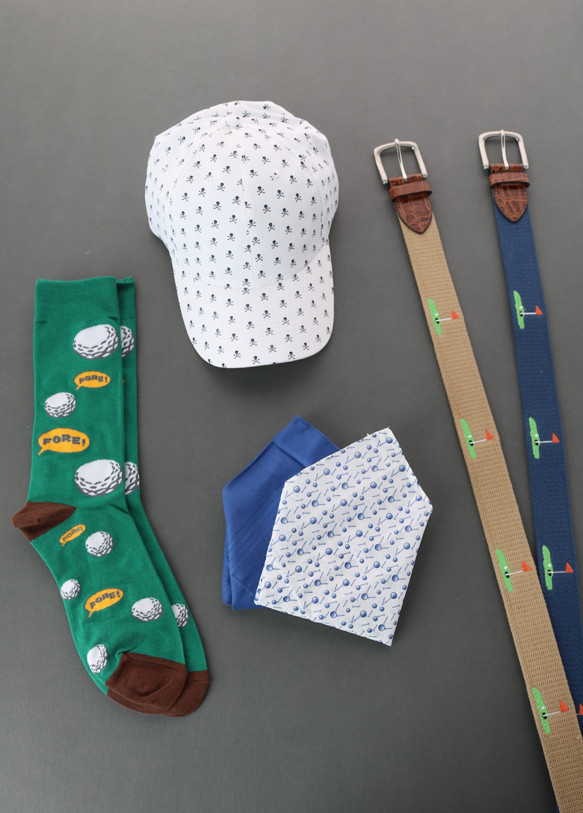 Various golf themed accessories including socks, handkerchiefs, belts, and a hat