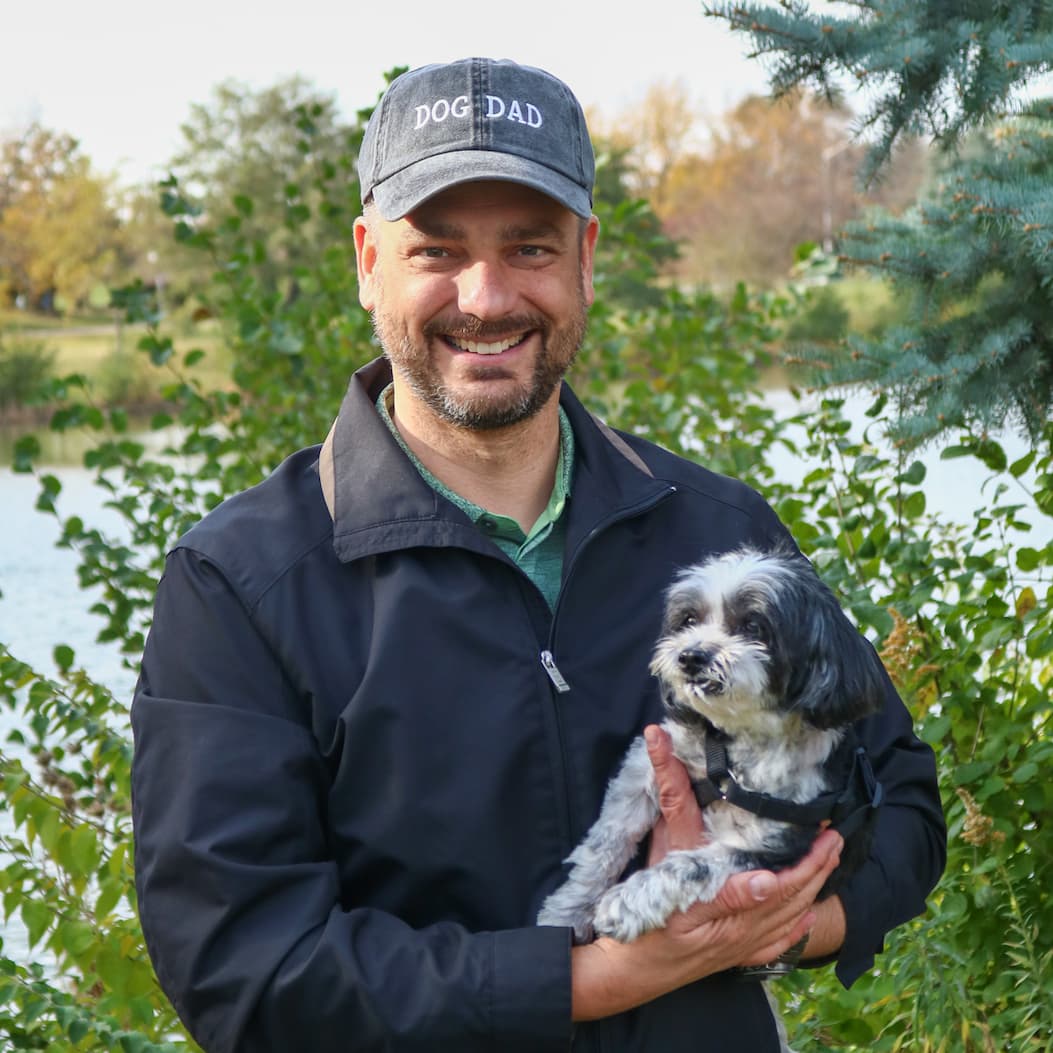 Man holding dog outside