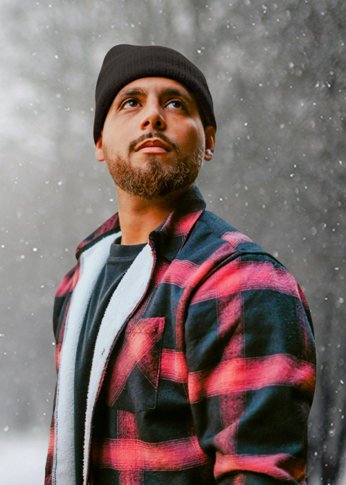 Man wearing coat and hat in the snow