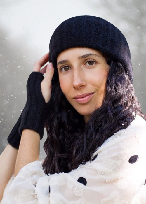 Woman wearing gloves, scarf and hat in the snow