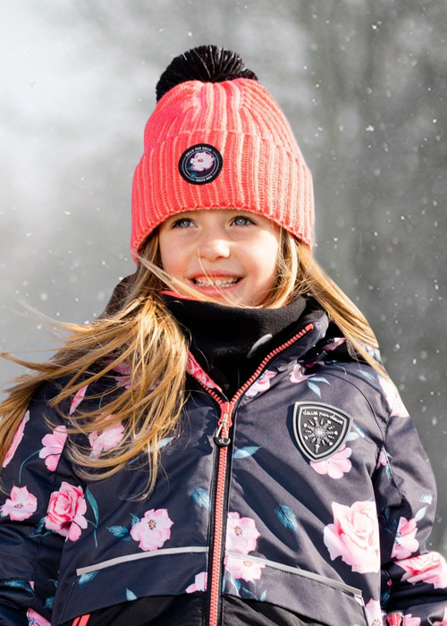 Girl wearing hat and coat in the snow
