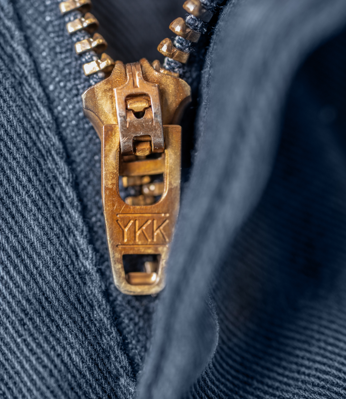 A close up of Navy Bills Khakis Heritage Wash shorts zipper detail
