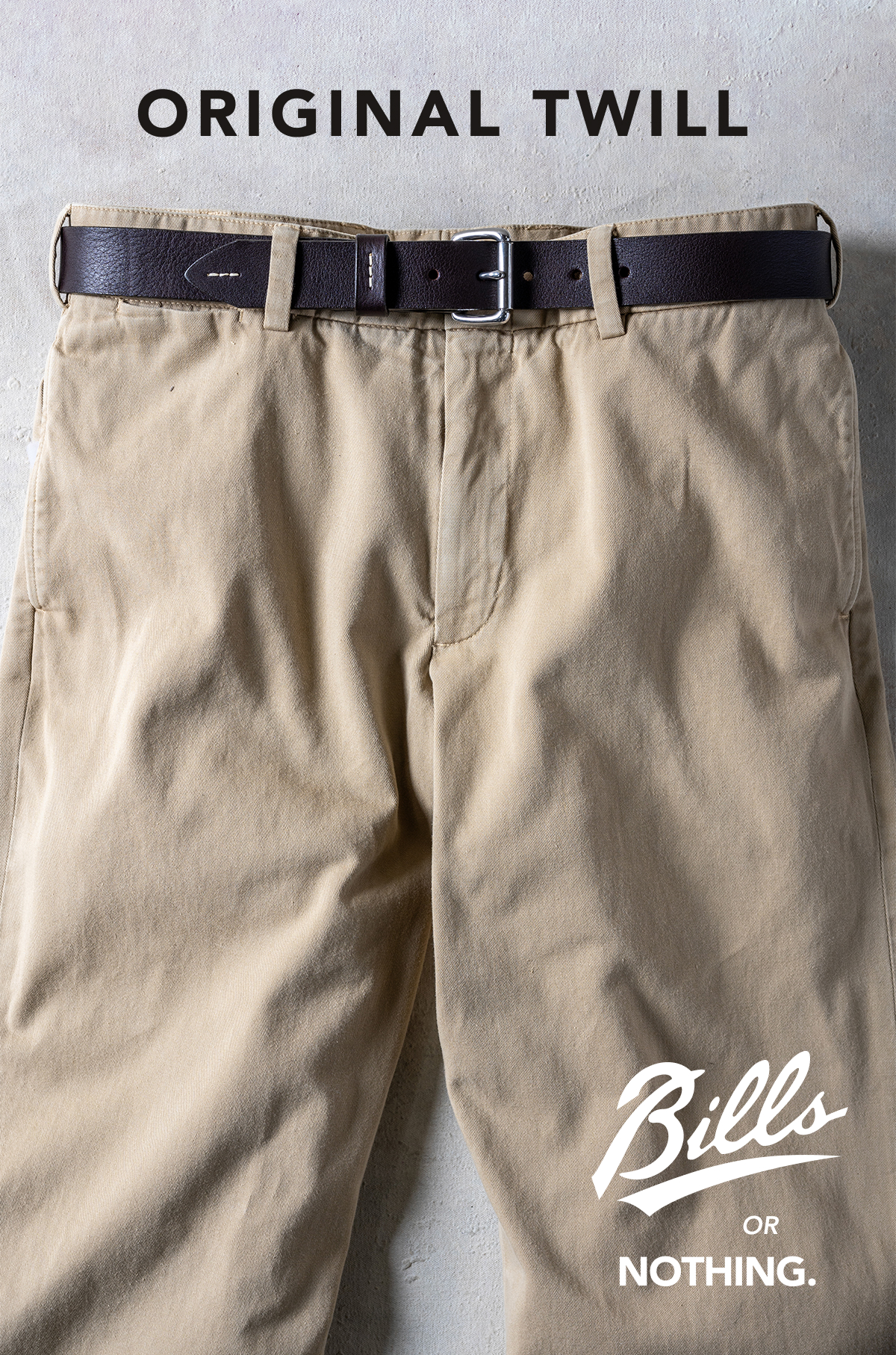 A crop of the top half of a pair of Bills Khakis khaki Original Twill pants. Text reads 
