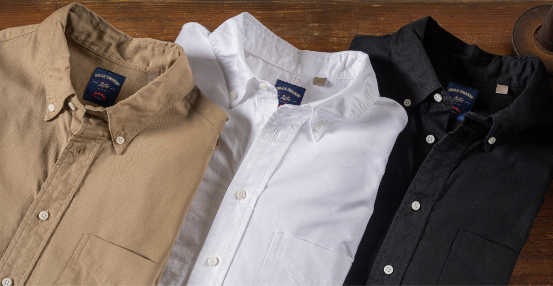 Three Bills Khakis Oxford Shirts Lay on a wooden surface