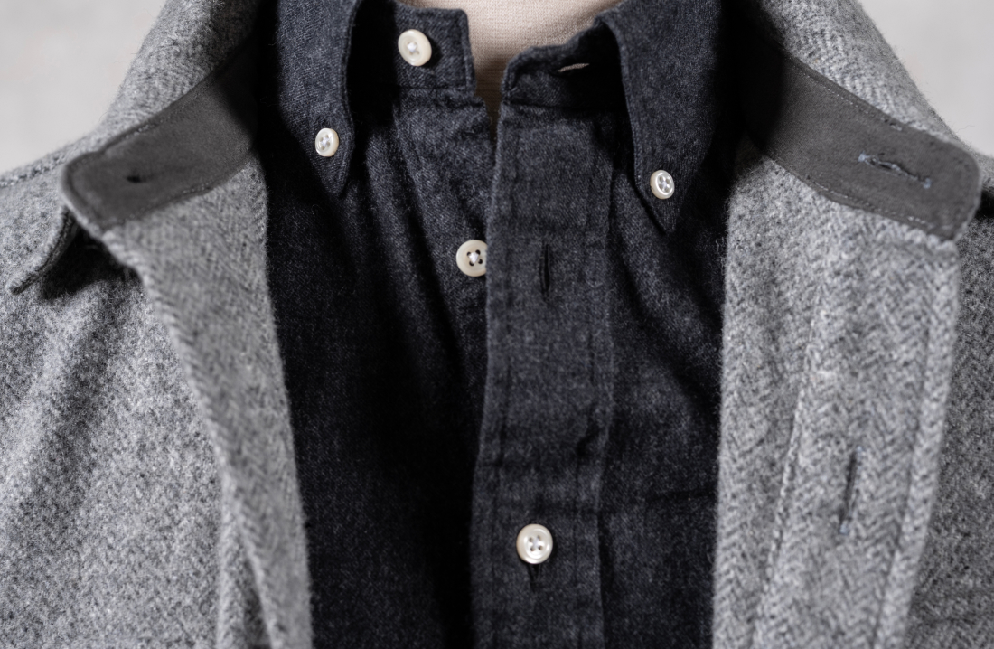 A close up of the color and top three buttons of a charcoal Bills Khakis brush flannel
