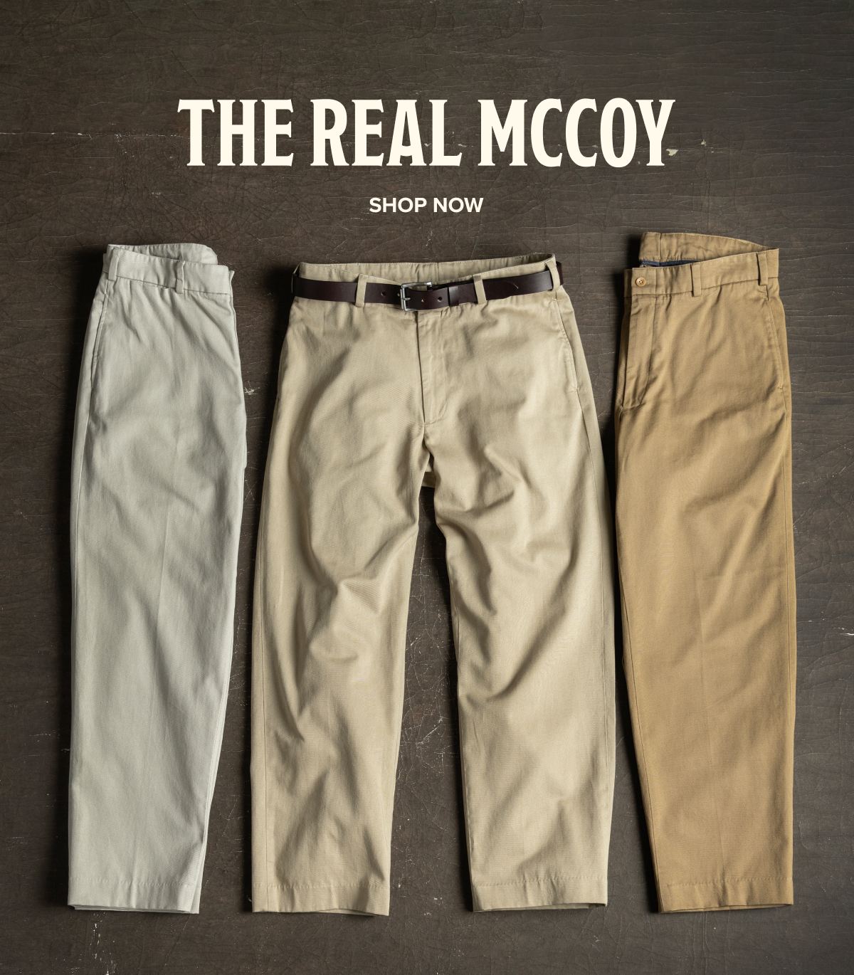 Three pairs of Bills Khakis M1 Khakis laid down on a dark brown, industrial surface. Text reads: 