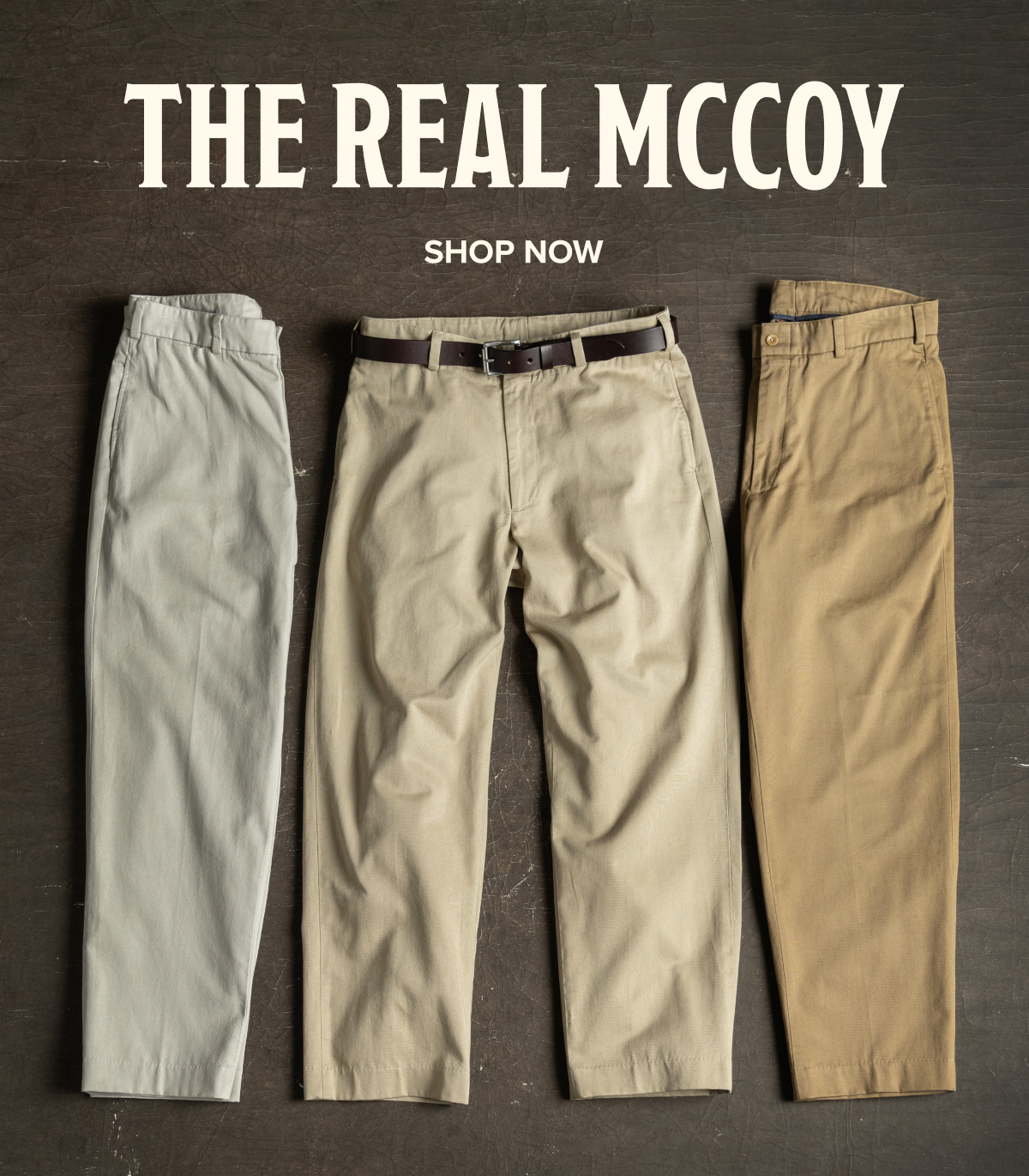 Three pairs of Bills Khakis M1 Khakis laid down on a dark brown, industrial surface. Text reads: 