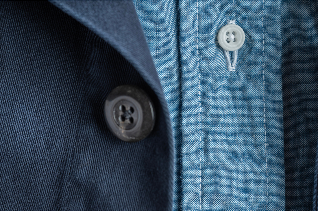 A detail of Bills Khakis Indigo overshirt and standard fit shirt