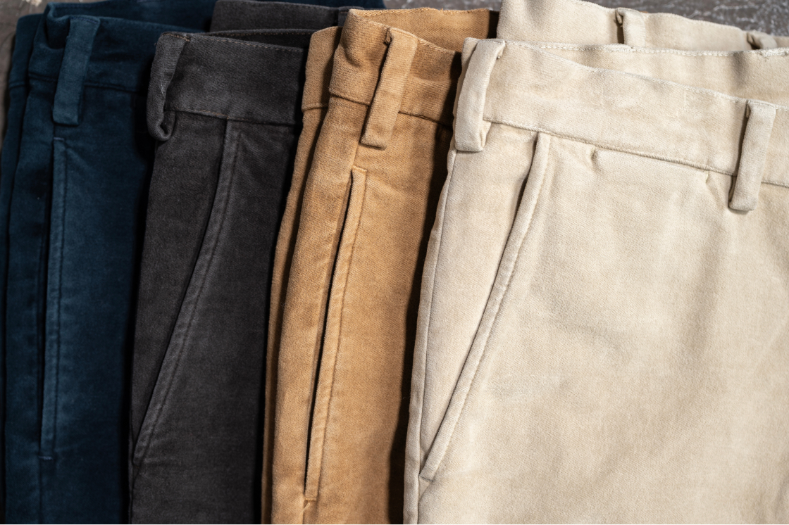 A closeup of four pairs of Bills Khaki moleskin pant pockets and right waist + belt loops tightly cropped in a frame to show off their detail and stitching