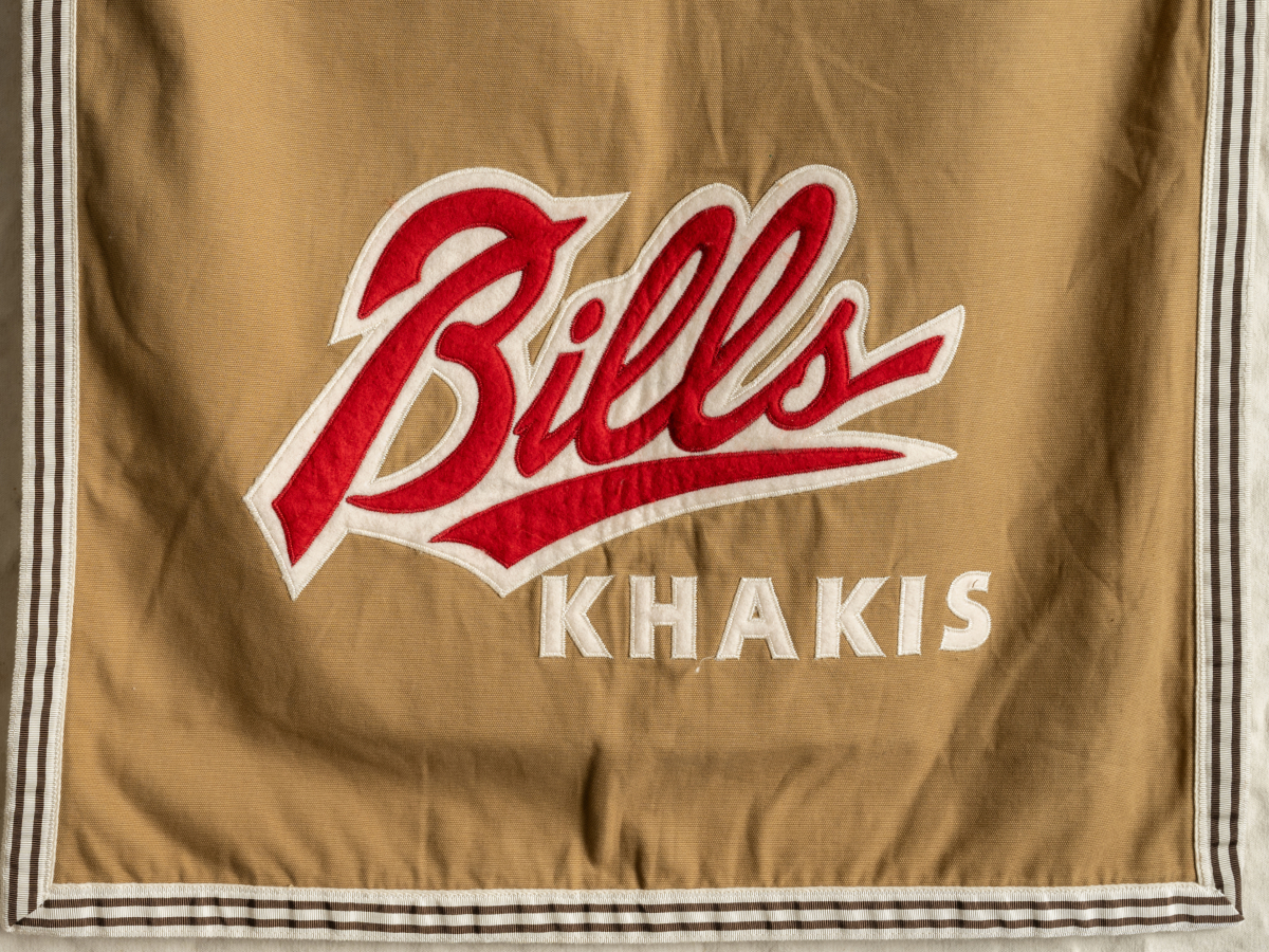Revive Logo | Pants Trade-In Program logo ontop of an image of vintage Bills Khakis flag.