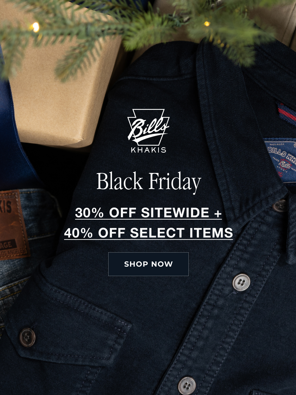 A close up crop of a navy Bills Khakis cover shirt sits folded alongside Bills Khaki denim and wrapped presents seemingly under a tree. Hints of pine poke into the out of focus foreground. A Bills Khakis logo sits in the foreground with text that reeads: Black Friday 30% Off Sitewide + 40% Select Items | Shop Now