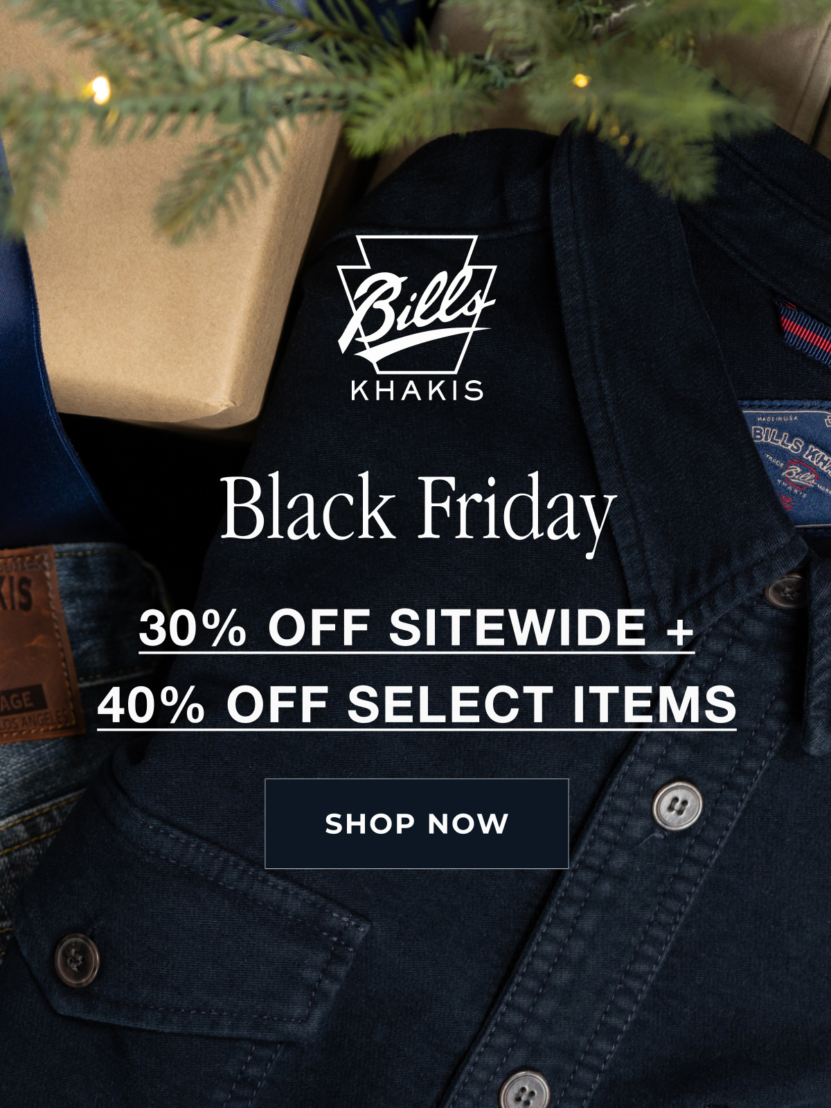 A close up crop of a navy Bills Khakis cover shirt sits folded alongside Bills Khaki denim and wrapped presents seemingly under a tree. Hints of pine poke into the out of focus foreground. A Bills Khakis logo sits in the foreground with text that reeads: Black Friday 30% Off Sitewide + 40% Select Items | Shop Now