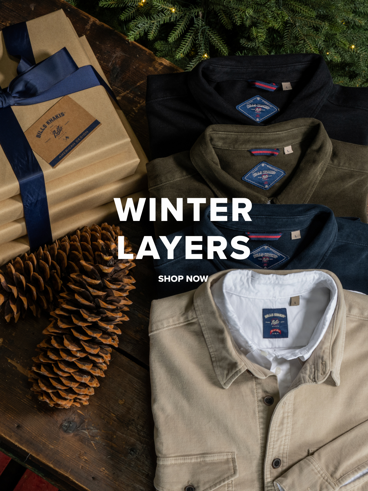 Four Bills Khakis overshirts folded on a dark walnut sruface with christmas presents, pine, and pinecones cropped alonge the borders